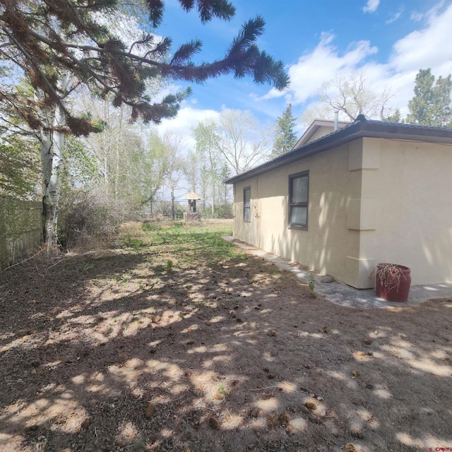 1016 Ln 12 N, Hooper, CO 81136 - view of side of property featuring stucco siding