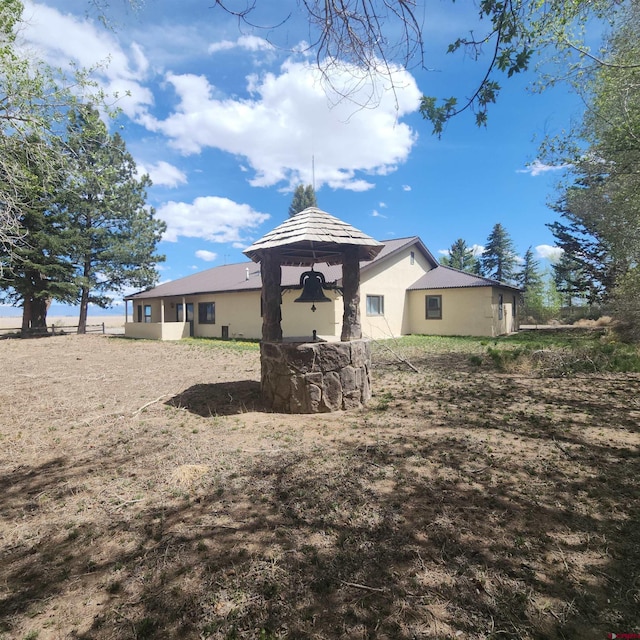 1016 Ln 12 N, Hooper, CO 81136 - back of property with a gazebo and stucco siding
