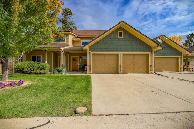 135 Eaton Dr Unit 1012, Pagosa Springs, CO 81147 - craftsman-style home featuring a garage, concrete driveway, a front yard, and stone siding