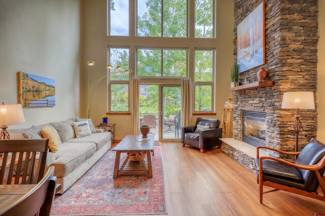 135 Eaton Dr Unit 1012, Pagosa Springs, CO 81147 - living room featuring a high ceiling, wood finished floors, and a fireplace