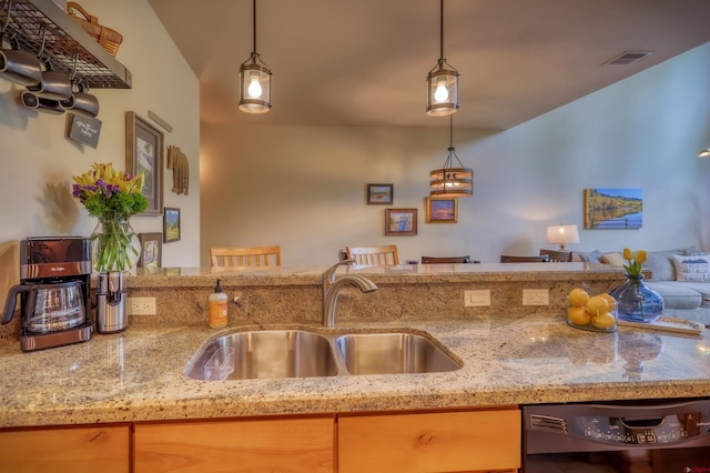 135 Eaton Dr Unit 1012, Pagosa Springs, CO 81147 - kitchen featuring a sink, black dishwasher, open floor plan, and light stone counters