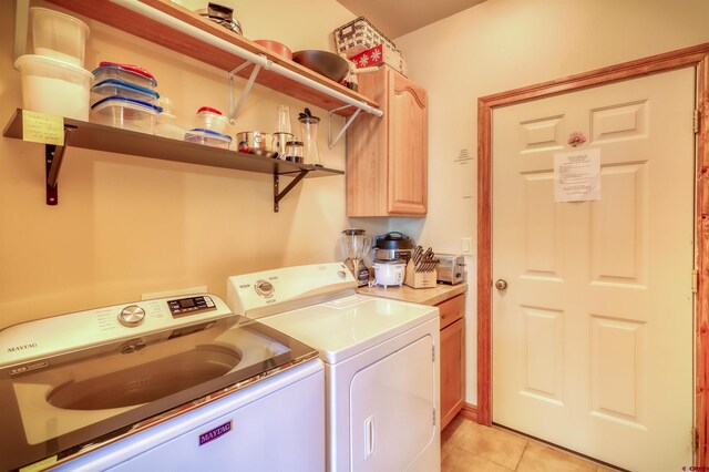135 Eaton Dr Unit 1012, Pagosa Springs, CO 81147 - washroom with washing machine and clothes dryer, cabinet space, and light tile patterned floors