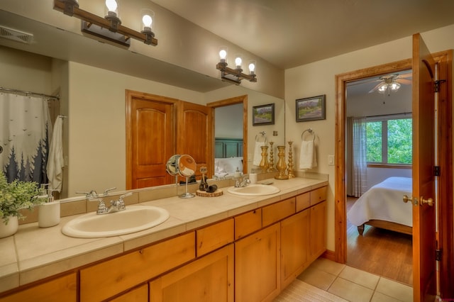135 Eaton Dr Unit 1012, Pagosa Springs, CO 81147 - bathroom with connected bathroom, tile patterned flooring, double vanity, and a ceiling fan