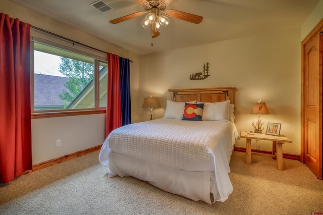 135 Eaton Dr Unit 1012, Pagosa Springs, CO 81147 - bedroom with light colored carpet, baseboards, and ceiling fan