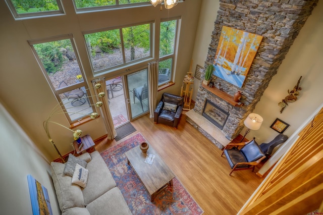 135 Eaton Dr Unit 1012, Pagosa Springs, CO 81147 - living area featuring a high ceiling, wood finished floors, healthy amount of natural light, and a fireplace