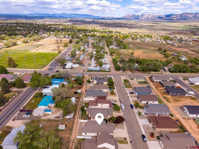 502 S Juniper Pl, Cortez, CO 81321 - aerial overview of property's location with a mountain backdrop and nearby suburban area