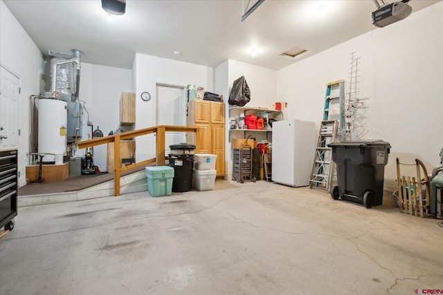 502 S Juniper Pl, Cortez, CO 81321 - garage featuring a garage door opener, freestanding refrigerator, heating unit, and gas water heater