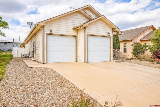502 S Juniper Pl, Cortez, CO 81321 - view of front of home featuring an attached garage, driveway, and fence
