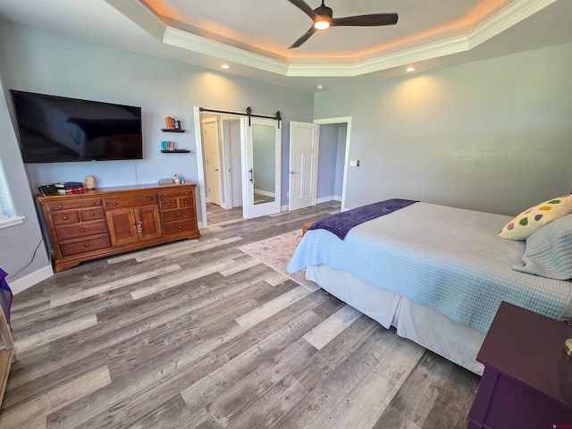 1771 Trappers Ct, Delta, CO 81416 - bedroom featuring a tray ceiling, ornamental molding, a barn door, wood finished floors, and recessed lighting