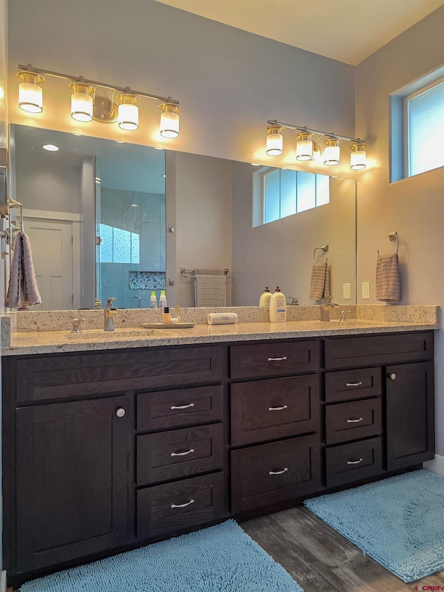 1771 Trappers Ct, Delta, CO 81416 - bathroom featuring a stall shower, double vanity, and wood finished floors