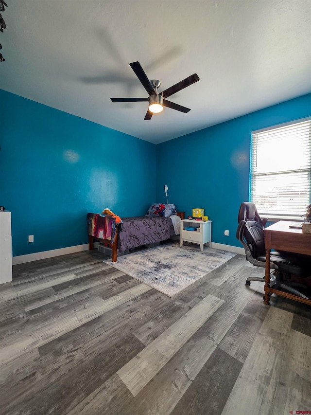 1771 Trappers Ct, Delta, CO 81416 - bedroom featuring wood finished floors, a ceiling fan, a desk, and baseboards