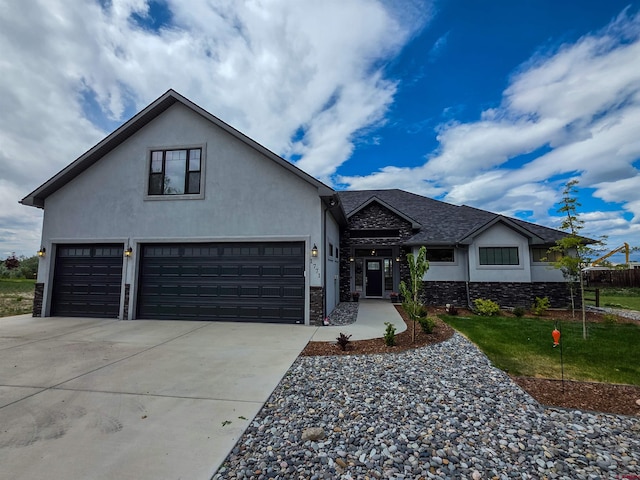 1771 Trappers Ct, Delta, CO 81416 - view of front of house featuring stucco siding, concrete driveway, stone siding, roof with shingles, and a garage