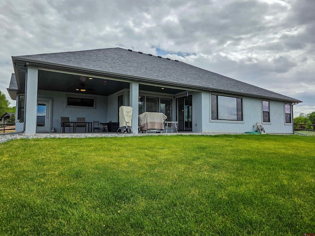 1771 Trappers Ct, Delta, CO 81416 - rear view of house with stucco siding, a lawn, a sunroom, and roof with shingles