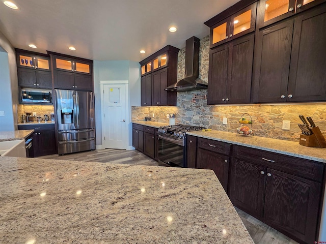 1771 Trappers Ct, Delta, CO 81416 - kitchen featuring stainless steel appliances, wall chimney exhaust hood, backsplash, light wood-type flooring, and recessed lighting