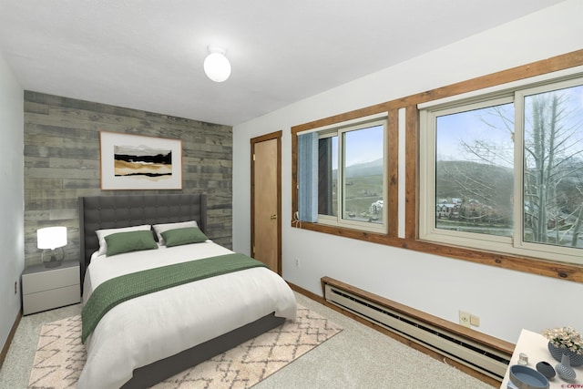 22 Castle Rd Unit 2, Mount Crested Butte, CO 81225 - bedroom featuring a baseboard heating unit, carpet, baseboards, and an accent wall