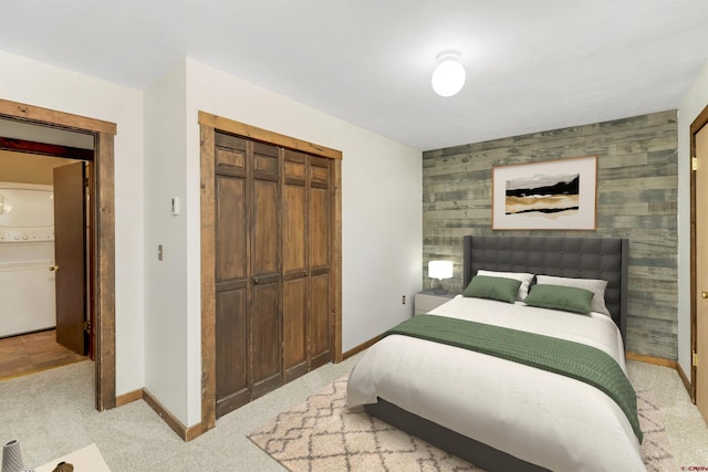 22 Castle Rd Unit 2, Mount Crested Butte, CO 81225 - bedroom featuring a closet, baseboards, light colored carpet, and an accent wall