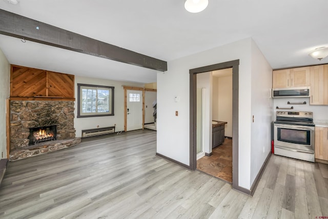 22 Castle Rd Unit 2, Mount Crested Butte, CO 81225 - kitchen with stainless steel appliances, a baseboard radiator, light brown cabinets, light wood-style flooring, and open floor plan