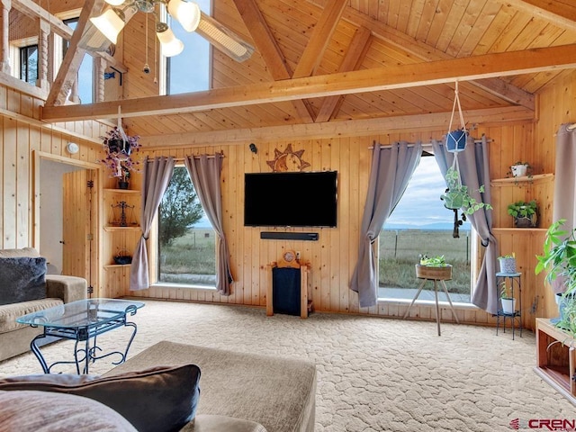 carpeted living area featuring wood walls, wood ceiling, and ceiling fan