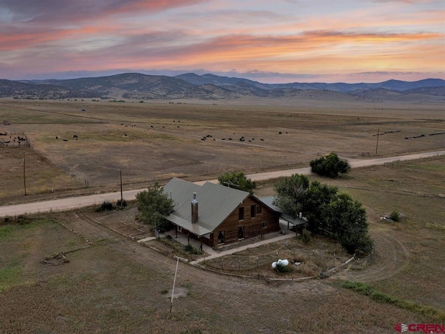 aerial view at dusk of a mountain view and a rural view