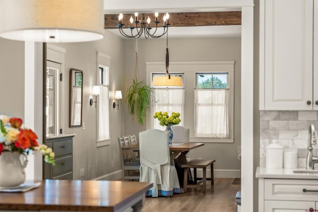 414 N Spruce St, Gunnison, CO 81230 - dining room with a chandelier, baseboards, wood finished floors, and beamed ceiling