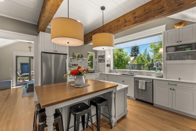 414 N Spruce St, Gunnison, CO 81230 - kitchen with stainless steel appliances, beam ceiling, butcher block countertops, light wood-style flooring, and healthy amount of natural light