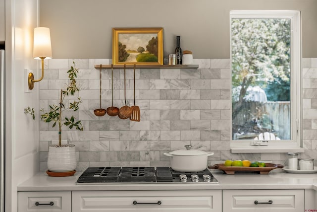 414 N Spruce St, Gunnison, CO 81230 - kitchen with stainless steel gas stovetop, light countertops, white cabinetry, and tasteful backsplash