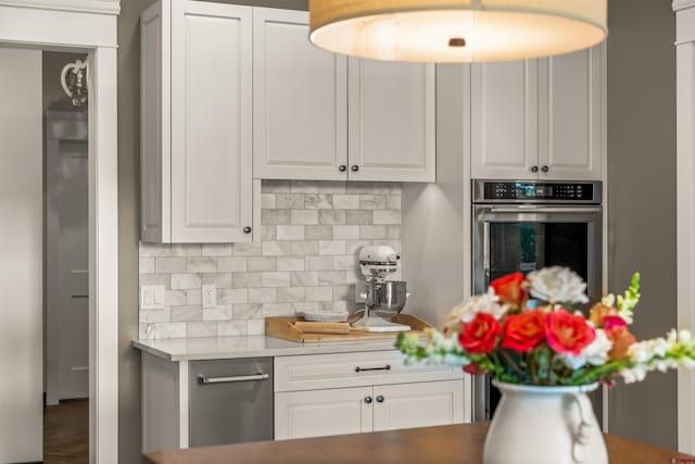 414 N Spruce St, Gunnison, CO 81230 - kitchen with oven, decorative backsplash, white cabinetry, and light countertops