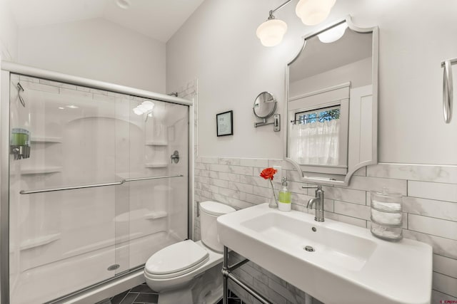 414 N Spruce St, Gunnison, CO 81230 - bathroom with tile walls, toilet, a shower stall, a sink, and wainscoting