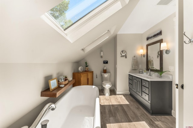 414 N Spruce St, Gunnison, CO 81230 - bathroom featuring a skylight, a freestanding tub, toilet, wood finished floors, and lofted ceiling