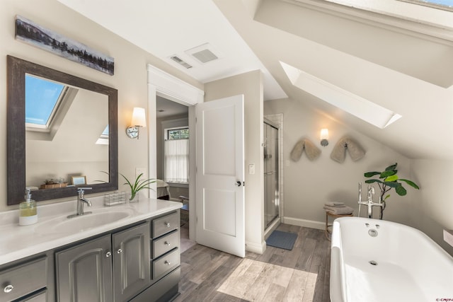 414 N Spruce St, Gunnison, CO 81230 - full bath featuring a skylight, wood finished floors, vanity, and a stall shower