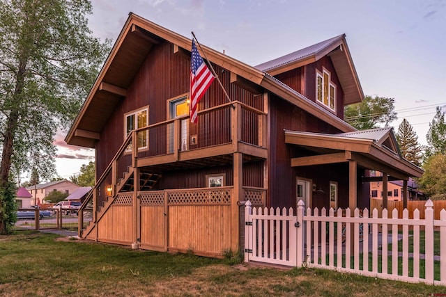 414 N Spruce St, Gunnison, CO 81230 - view of front facade featuring a gate, metal roof, a balcony, and a fenced front yard
