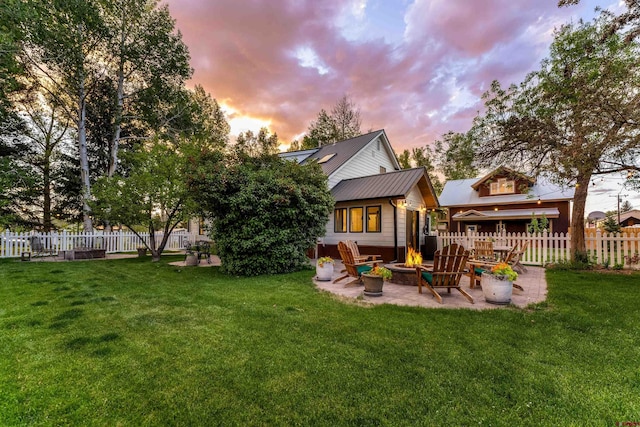 414 N Spruce St, Gunnison, CO 81230 - rear view of property with a patio area, a fire pit, and metal roof
