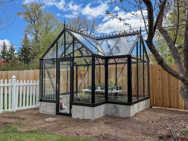 414 N Spruce St, Gunnison, CO 81230 - view of property exterior with a greenhouse, an outdoor structure, and a fenced backyard