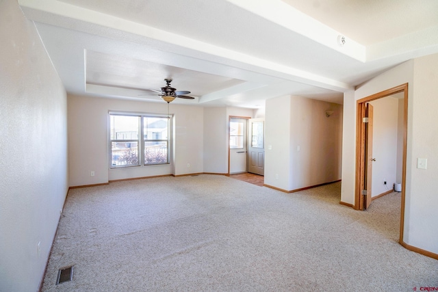 801 L Way, Cortez, CO 81321 - spare room with light colored carpet, ceiling fan, a tray ceiling, and baseboards