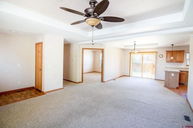 801 L Way, Cortez, CO 81321 - unfurnished living room featuring a raised ceiling, light carpet, and baseboards
