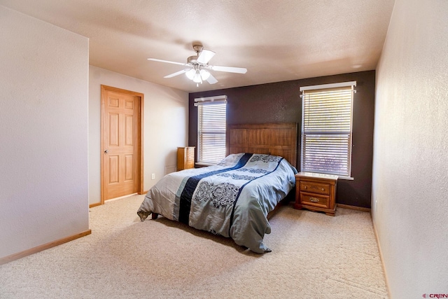 801 L Way, Cortez, CO 81321 - bedroom featuring light colored carpet, a textured wall, ceiling fan, and baseboards