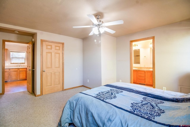 801 L Way, Cortez, CO 81321 - bedroom featuring a sink, light colored carpet, ensuite bath, baseboards, and ceiling fan