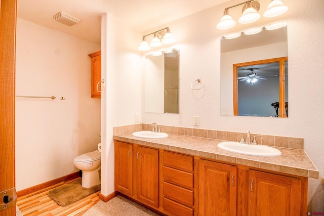 801 L Way, Cortez, CO 81321 - full bathroom featuring toilet, a ceiling fan, and double vanity