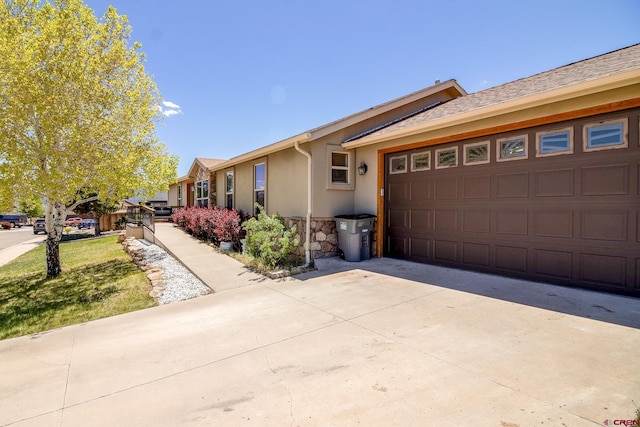 801 L Way, Cortez, CO 81321 - ranch-style home featuring stone siding, an attached garage, stucco siding, and concrete driveway