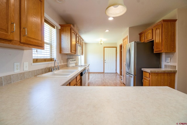 801 L Way, Cortez, CO 81321 - kitchen with a sink, white appliances, brown cabinets, light countertops, and recessed lighting