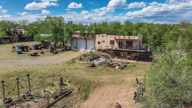 8041/2 S Broadway, Cortez, CO 81321 - view of front of home with stucco siding, a garage, driveway, and a wooden deck