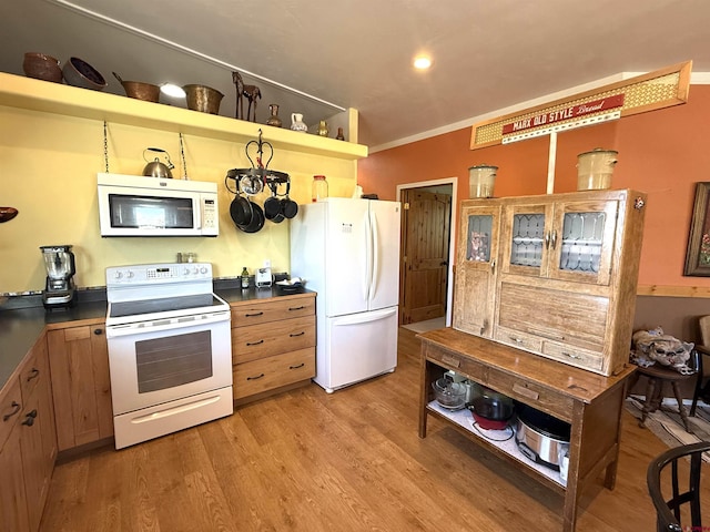 8041/2 S Broadway, Cortez, CO 81321 - kitchen with white appliances, open shelves, light wood finished floors, dark countertops, and crown molding