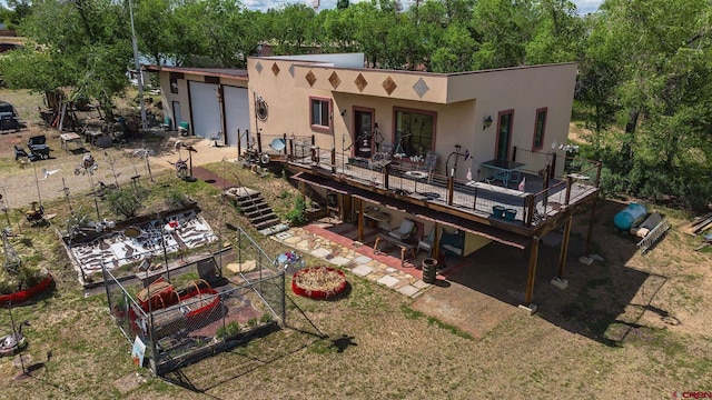 8041/2 S Broadway, Cortez, CO 81321 - rear view of house with a deck, stucco siding, and a garage