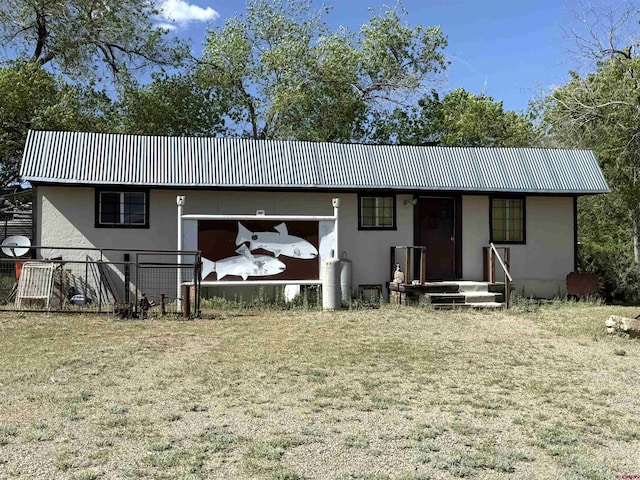 8041/2 S Broadway, Cortez, CO 81321 - view of front of property featuring stucco siding, an attached garage, and fence