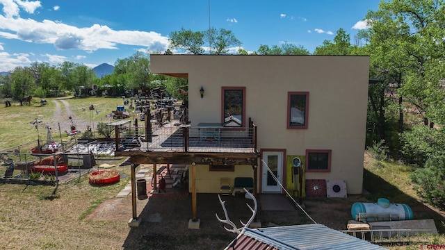 8041/2 S Broadway, Cortez, CO 81321 - rear view of property featuring stucco siding, a patio area, and a wooden deck