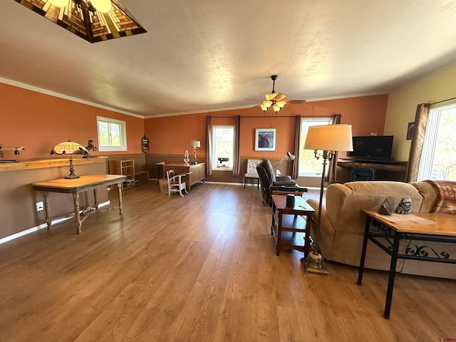 8041/2 S Broadway, Cortez, CO 81321 - living room featuring wood finished floors, healthy amount of natural light, ceiling fan, baseboards, and ornamental molding
