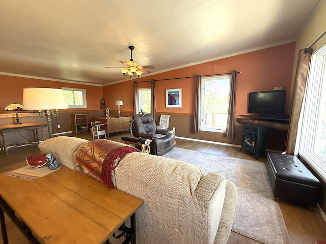 8041/2 S Broadway, Cortez, CO 81321 - living area featuring wood finished floors, a ceiling fan, baseboards, ornamental molding, and a wood stove