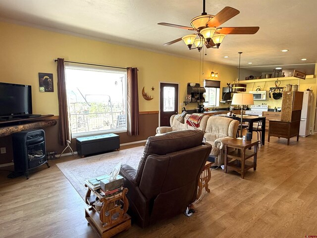 8041/2 S Broadway, Cortez, CO 81321 - living room featuring a wood stove, light wood-type flooring, ceiling fan, and recessed lighting