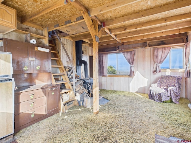 351 Slide Down Rd, Crawford, CO 81415 - interior space featuring a wood stove, carpet flooring, and wood walls
