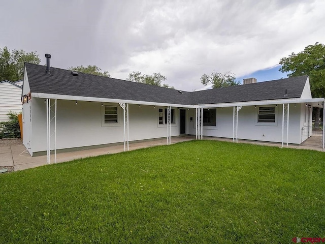1749 N 15th St, Grand Junction, CO 81501 - rear view of house featuring a patio area, a yard, and a shingled roof